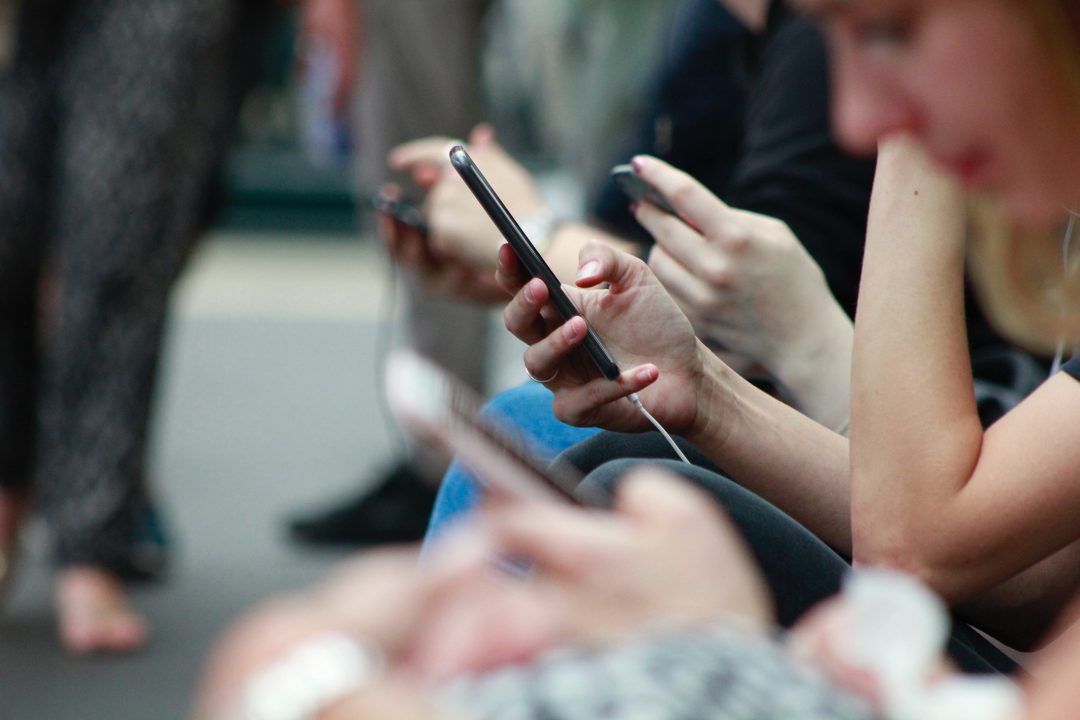 Imafe of people sitting with social media watch